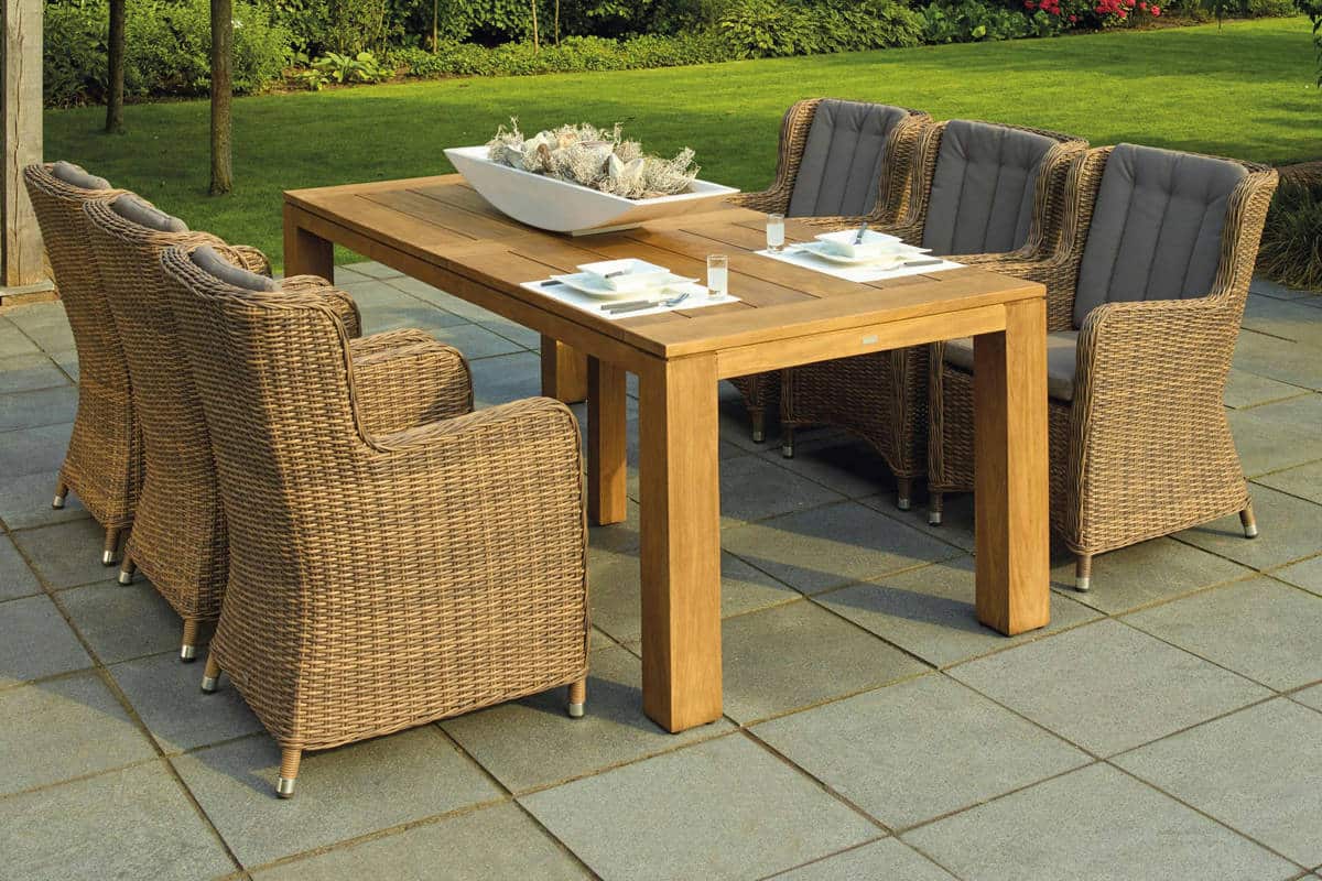 Great-looking chairs and table set up on a newly paved outdoor living area from Laika Construction.